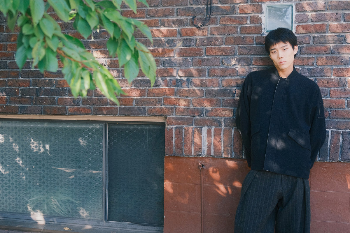 New Arrivals Model Standing Against Brick Wall