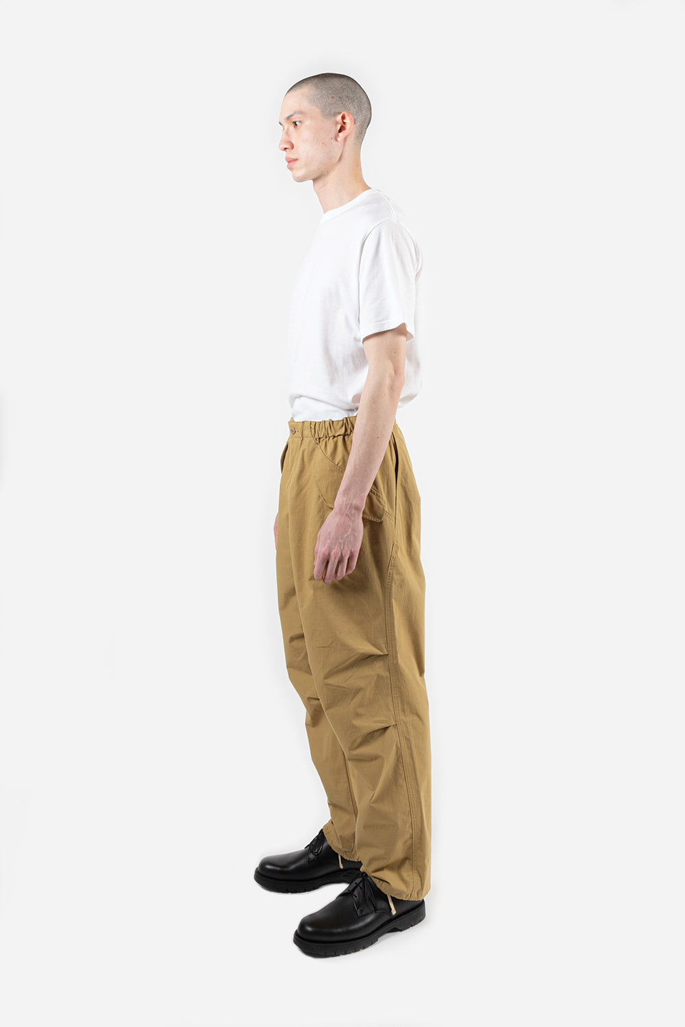 https://wallacemercantileshop.com/cdn/shop/products/goldwin-wide-easy-wind-pants-beige-angle.jpg?v=1616097050